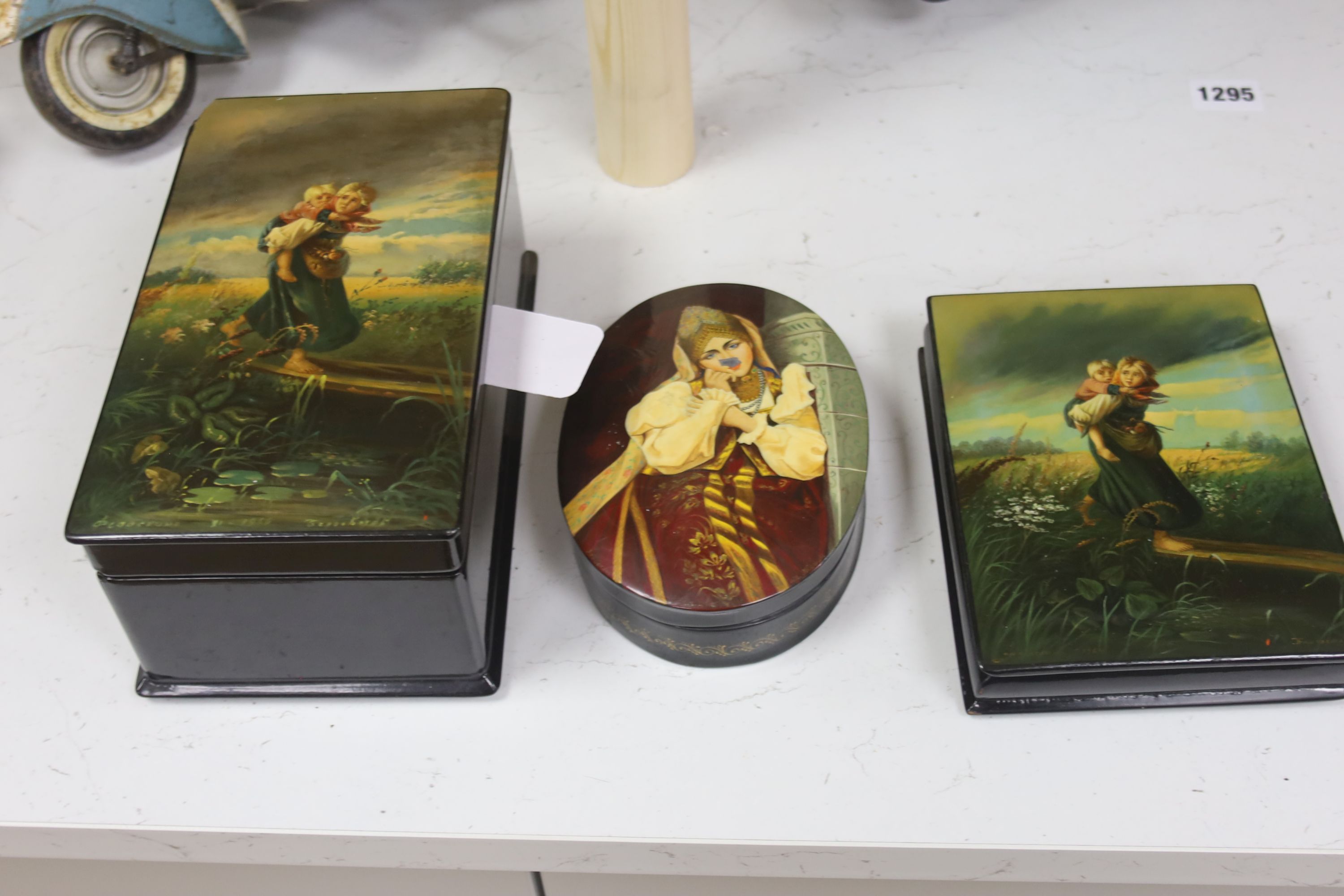 Six Russian Papier mache boxes, each decorated with a young girl or woman, the largest 21.5 cm